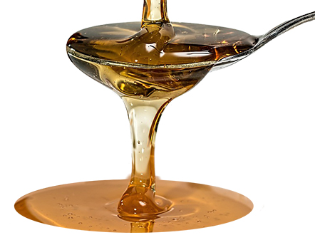 photo of honey-like liquid pour into and over a spoon